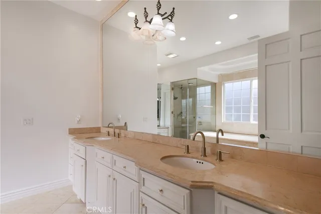 a bathroom with a sink double vanity and a mirror