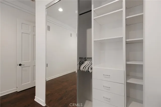 a view of walk in closet with empty racks