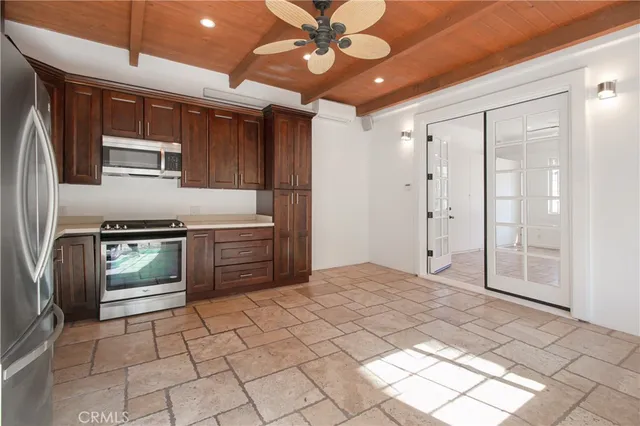 a kitchen with stainless steel appliances granite countertop a stove a sink and a refrigerator