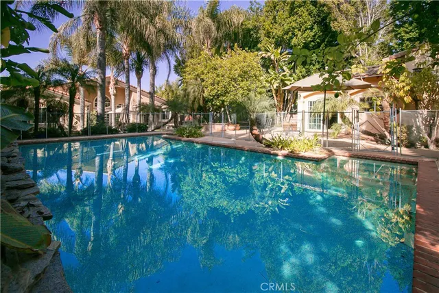 a swimming pool with outdoor seating and yard
