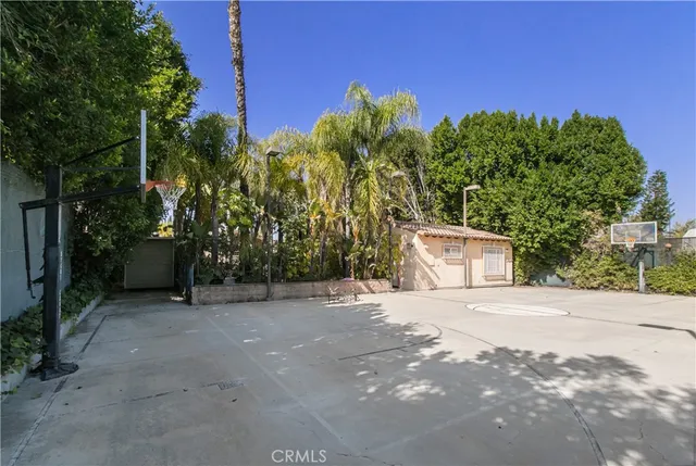 a backyard of a house with lots of green space and fountain