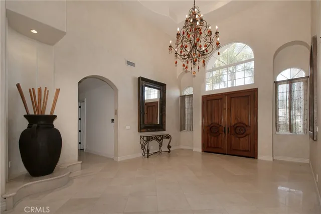 a view of entryway with chandelier and front door
