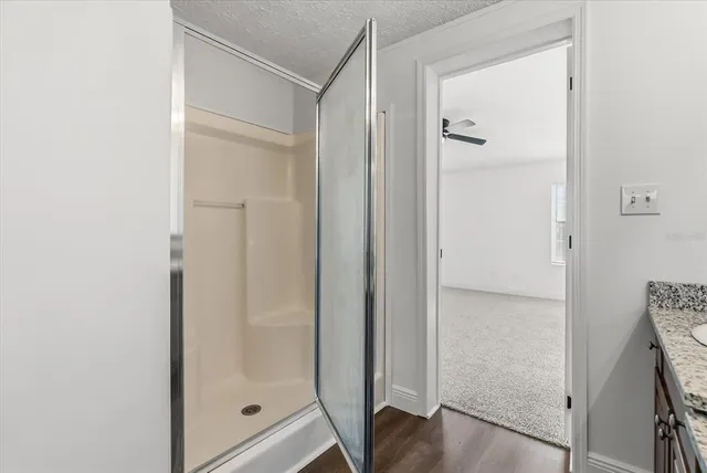 a bathroom with a glass shower door