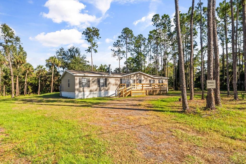 1785 Marsh Way Geneva, FL 32732 - Photo 5 of 40 a view of swimming pool with trees and buildings in the background