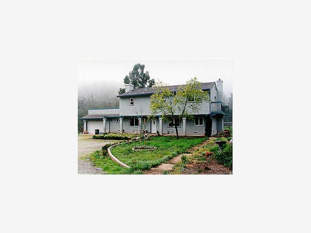 a view of house with backyard and seating space