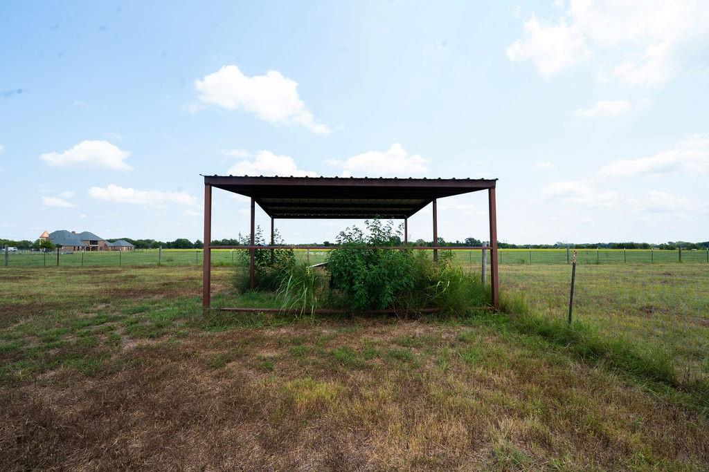 1901 Hunsucker Road Red Oak, TX 75152 - Photo 14 of 15 a backyard of a house with lots of green space and lake view
