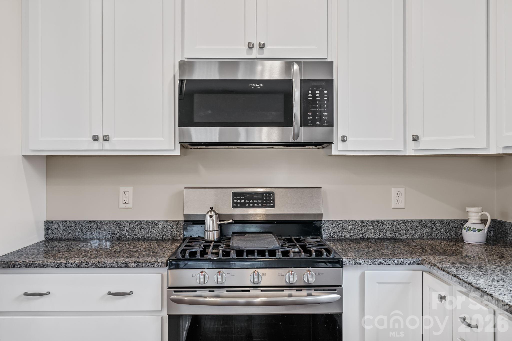 57 Parrot Road Candler, NC 28715 - Photo 12 of 44 a stove top oven sitting inside of a kitchen