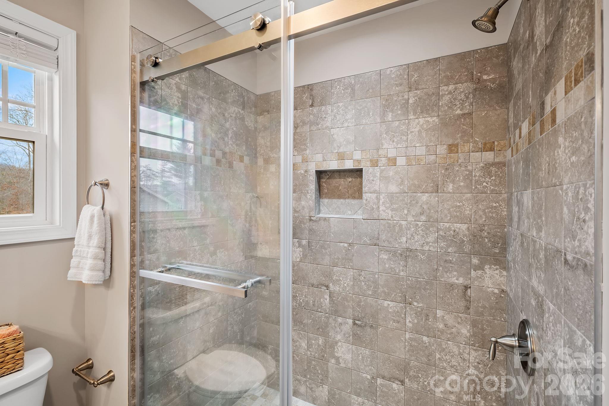 57 Parrot Road Candler, NC 28715 - Photo 23 of 44 a bathroom with a toilet and a shower