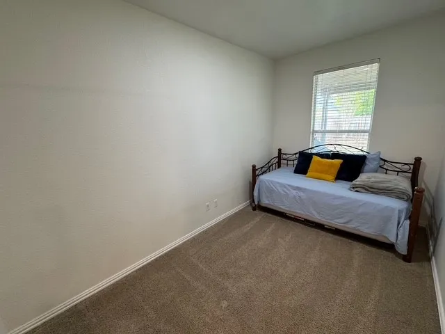 a bedroom with a bed and window