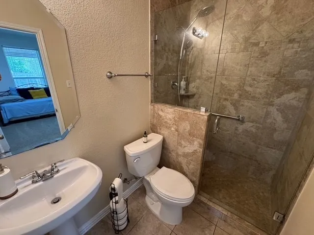 a bathroom with a toilet sink and shower