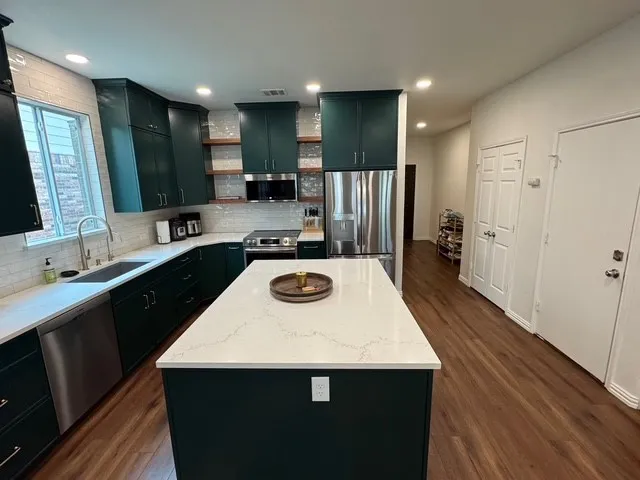 a kitchen with a sink a stove and refrigerator