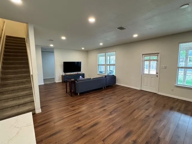 a living room with furniture and flat screen tv