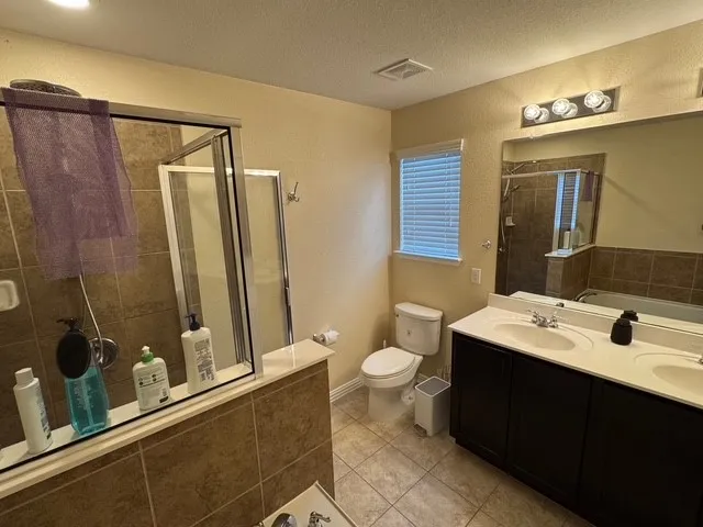 a bathroom with a sink vanity mirror and toilet