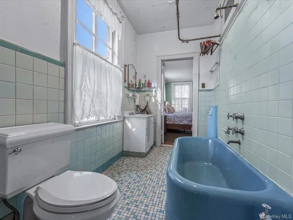 a bathroom with a sink a toilet and mirror