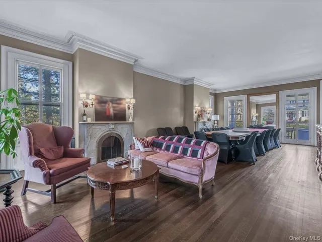 a living room with furniture wooden floor and a large window