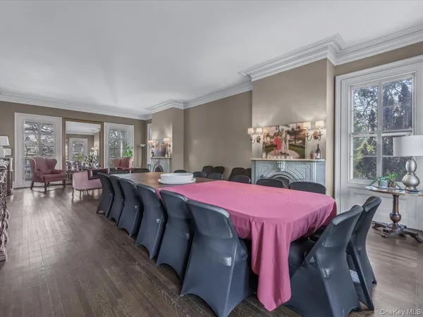 a dining room with a wooden table and chairs