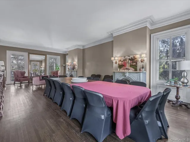 a dining room with a wooden table and chairs