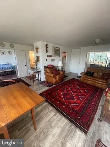 a living room with furniture pool table and a window