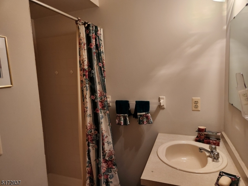 8 Acapulco Princess, Unit 2 Vernon, NJ 07462 - Photo 11 of 13 a bathroom with a sink and mirror