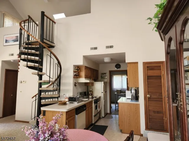 a kitchen with stainless steel appliances granite countertop a stove and a refrigerator
