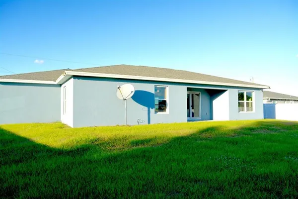 a front view of house with yard and trees