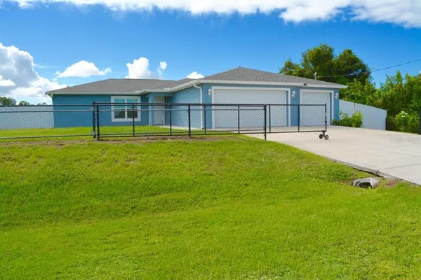 a view of a house with a backyard and a patio