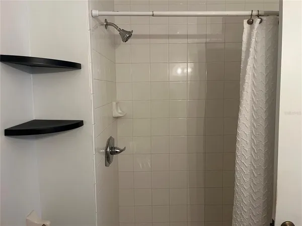 a bathroom with a shower and a shower
