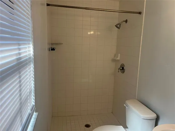 a bathroom with a shower toilet and sink