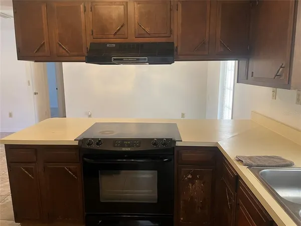 a kitchen with a stove a sink and a microwave