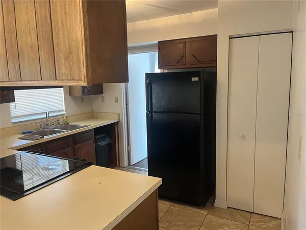a kitchen with a refrigerator and a sink