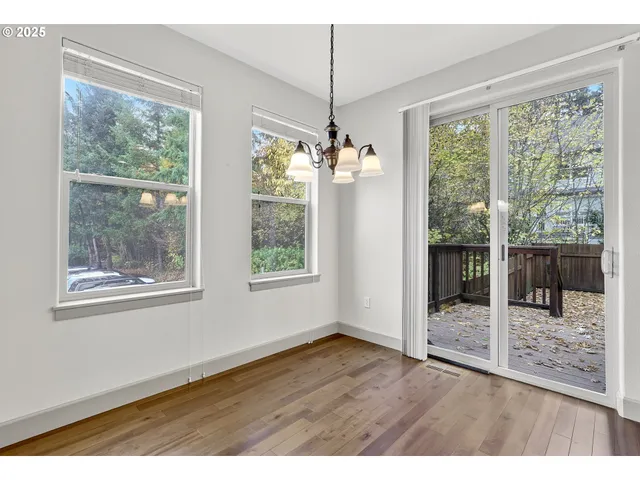 a kitchen with stainless steel appliances granite countertop a stove a sink and a refrigerator with wooden floor