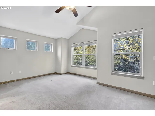an empty room with windows and closet