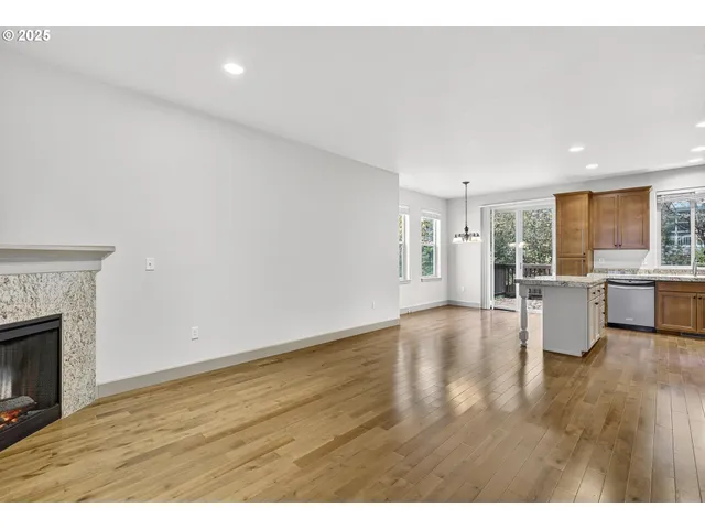 a kitchen with kitchen island a counter top space cabinets and stainless steel appliances