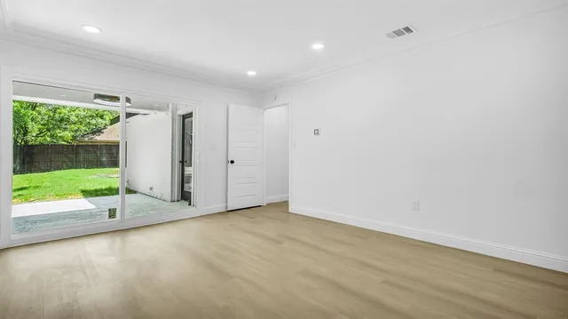 an empty room with yard and a large window