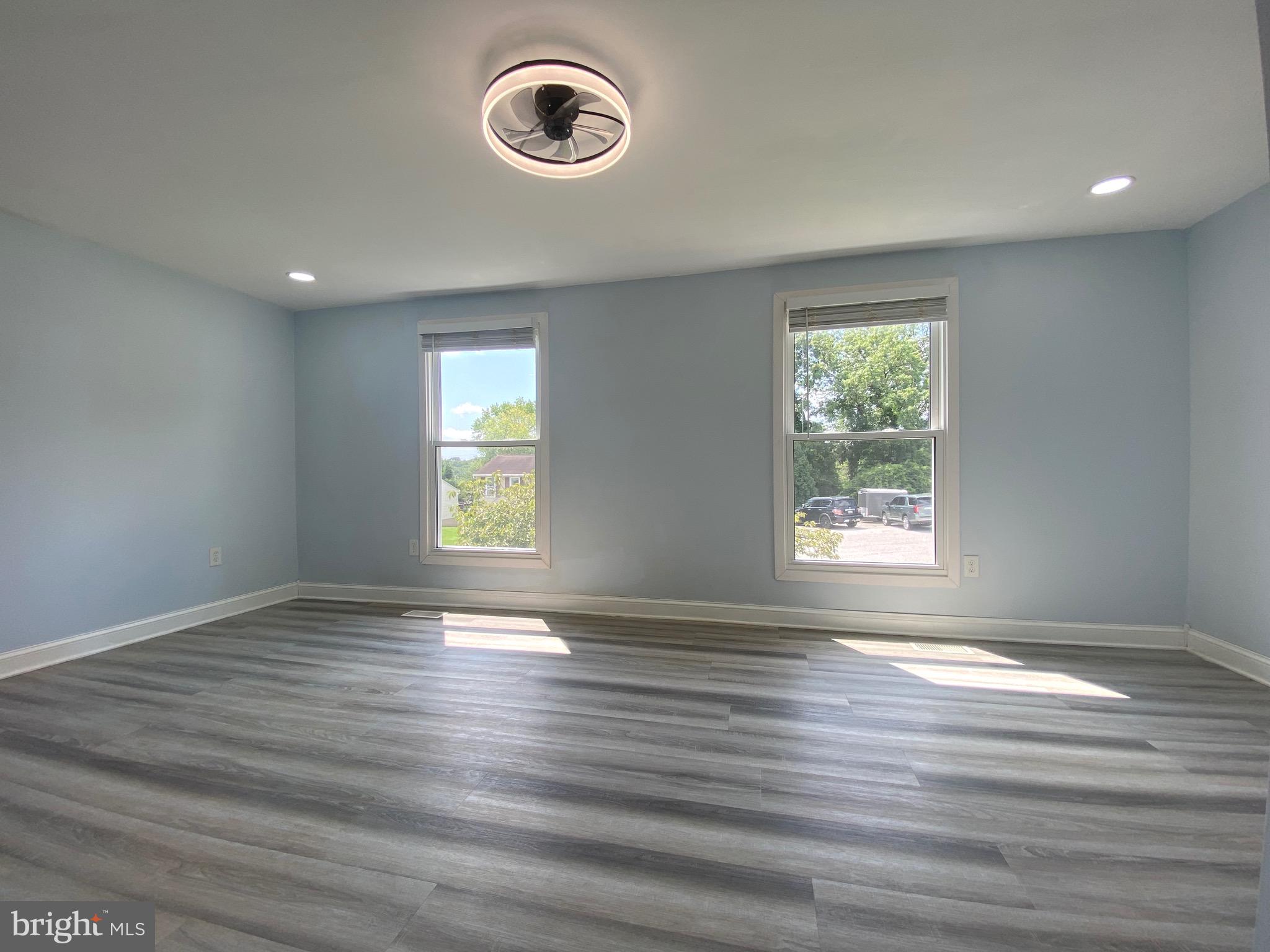 18 1st Light Court Rosedale, MD 21237 - Photo 11 of 29 an empty room with wooden floor and windows
