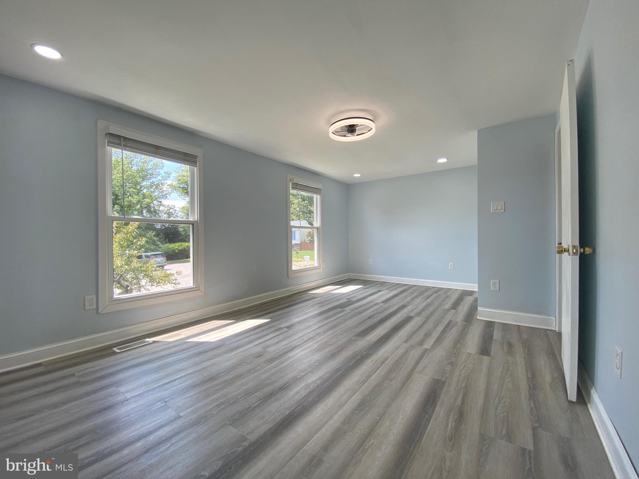 18 1st Light Court Rosedale, MD 21237 - Photo 13 of 29 an empty room with wooden floor and windows