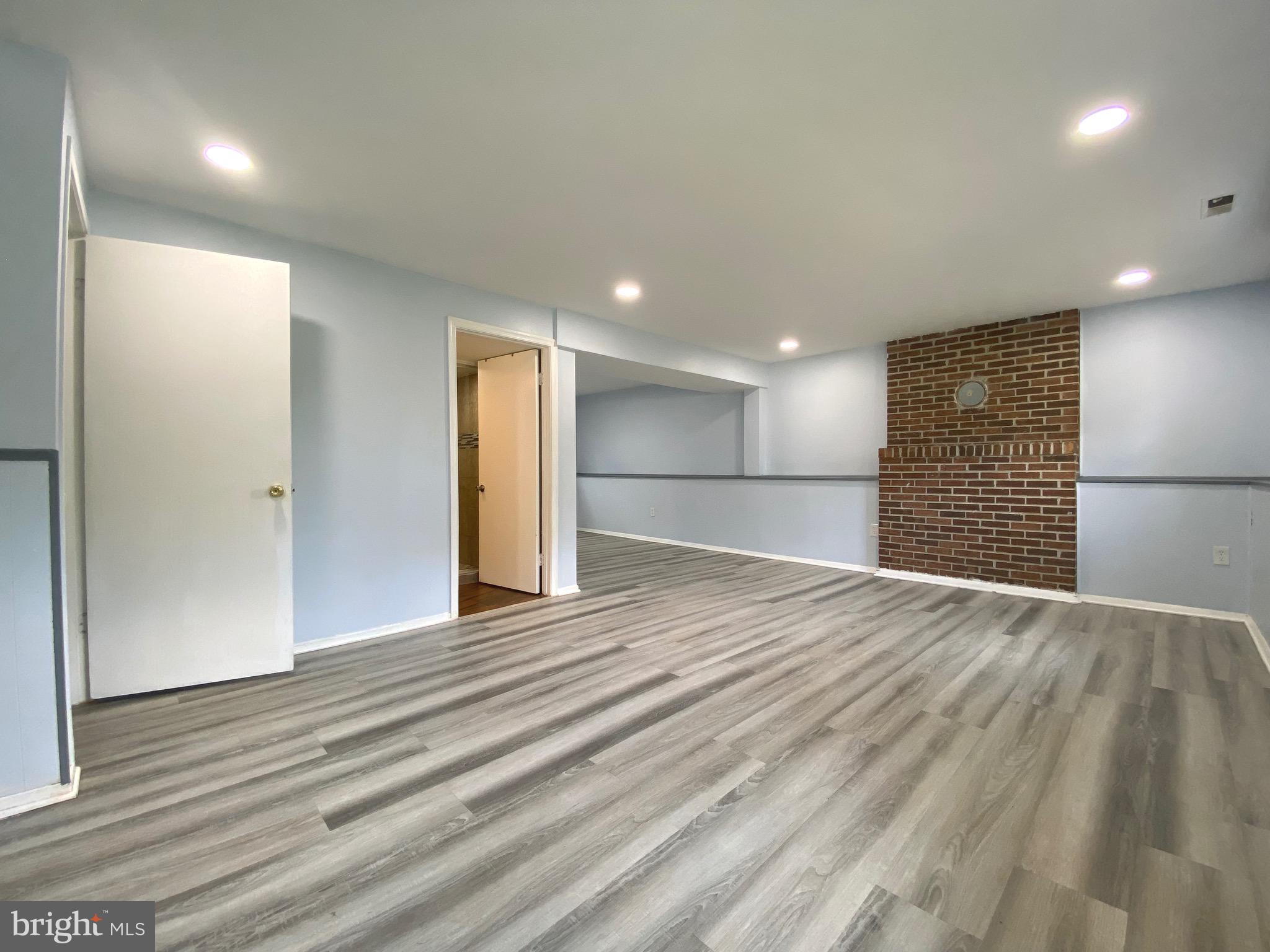 18 1st Light Court Rosedale, MD 21237 - Photo 15 of 29 a view of an empty room with wooden floor and a kitchen