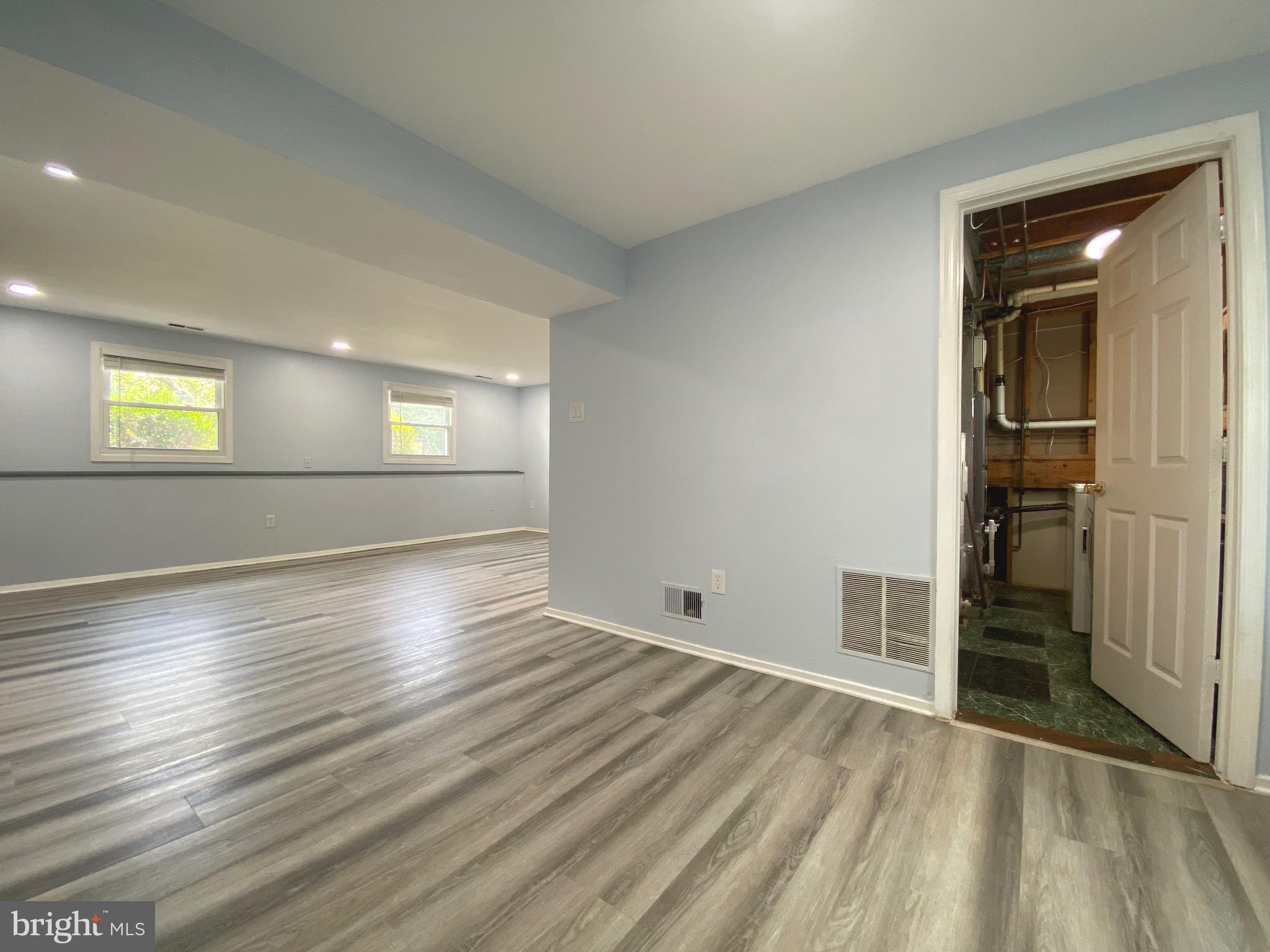 18 1st Light Court Rosedale, MD 21237 - Photo 17 of 29 an empty room with wooden floor and windows