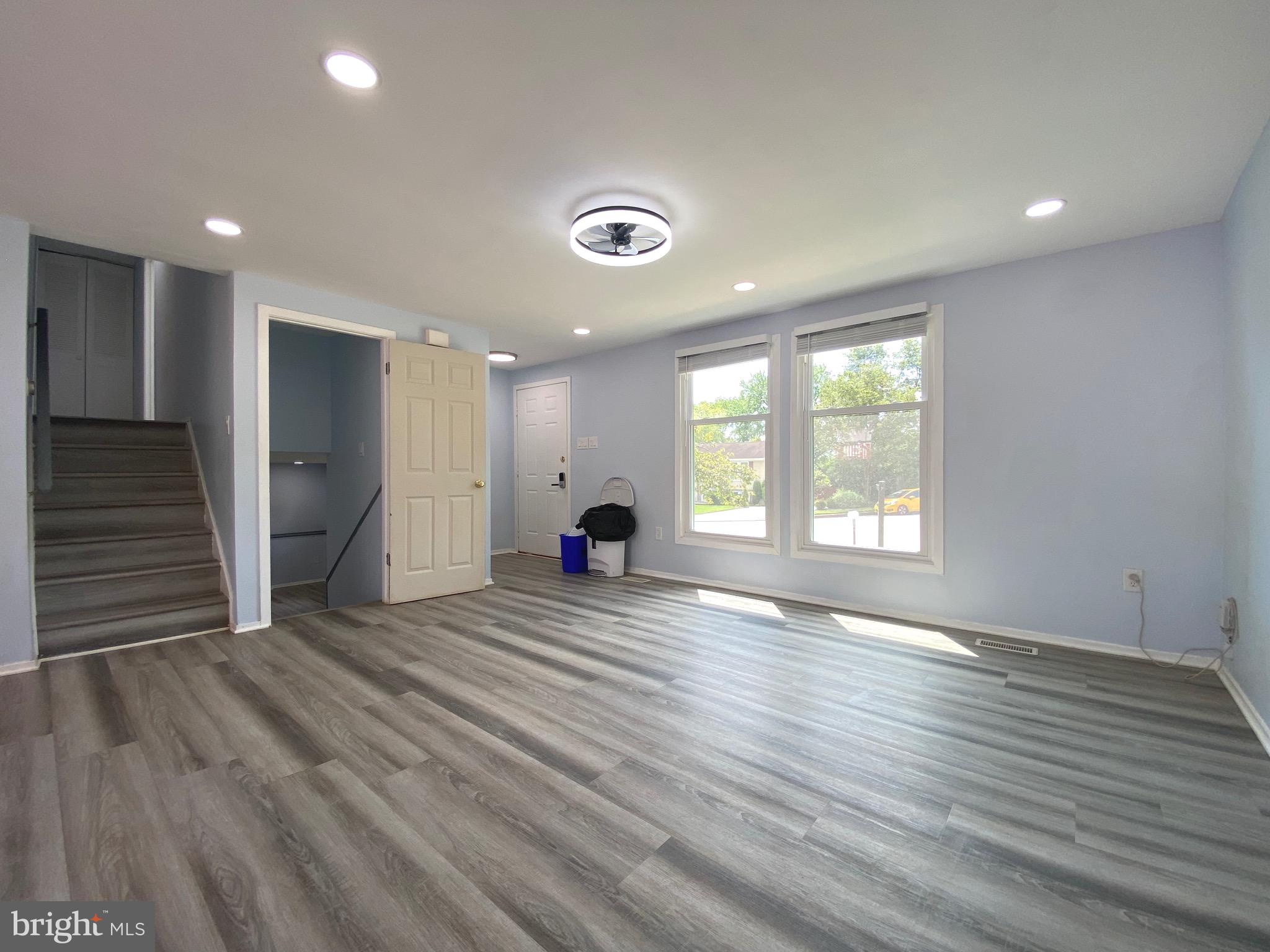 18 1st Light Court Rosedale, MD 21237 - Photo 4 of 29 an empty room with wooden floor and windows