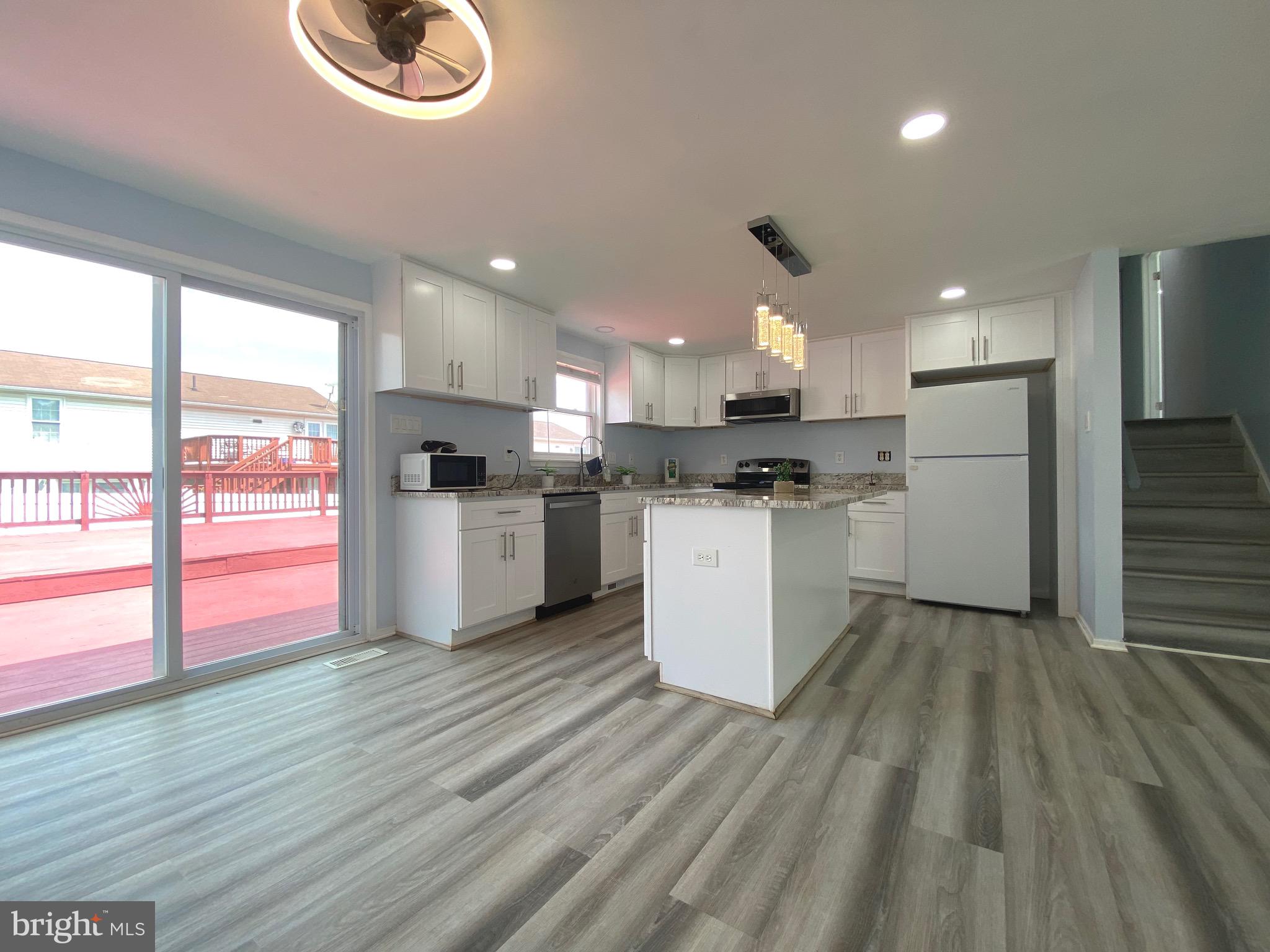 18 1st Light Court Rosedale, MD 21237 - Photo 5 of 29 a large kitchen with cabinets and wooden floor