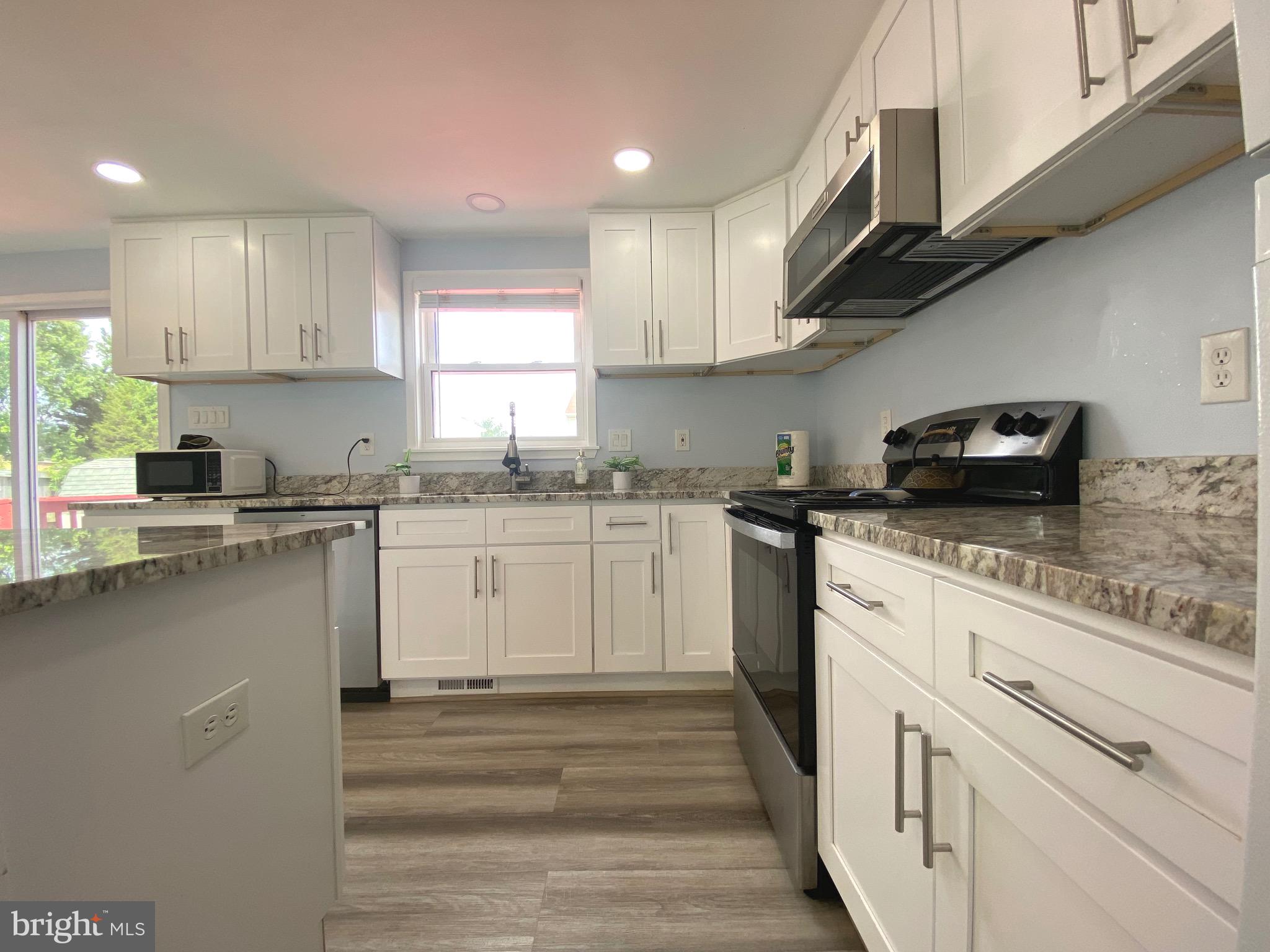 18 1st Light Court Rosedale, MD 21237 - Photo 6 of 29 a kitchen with granite countertop white cabinets and white appliances
