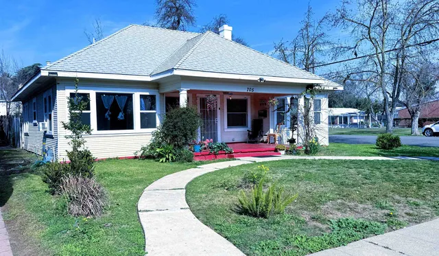 a front view of a house with a yard and porch