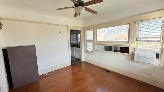 a view of a livingroom with a ceiling fan and a window