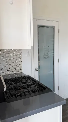 a close view of a stove a sink and dishwasher in a kitchen