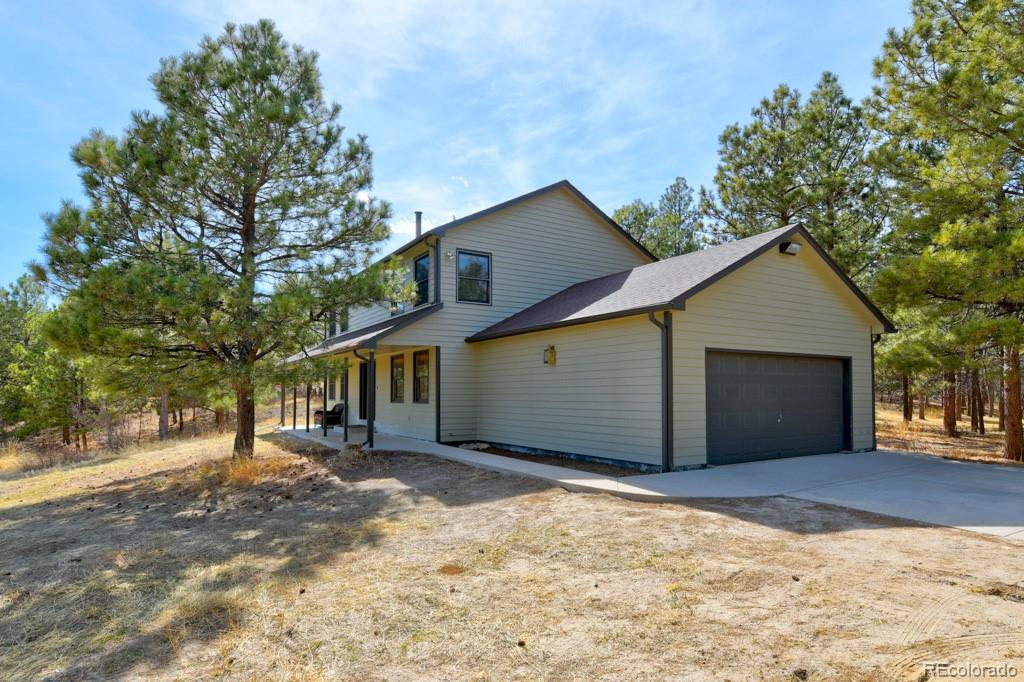 18673 North Elbert Road Elbert, CO 80106 - Photo 2 of 50 a front view of a house with a yard and garage