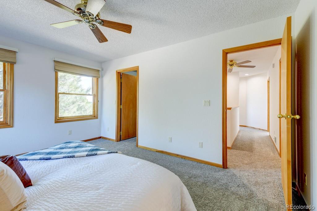 18673 North Elbert Road Elbert, CO 80106 - Photo 23 of 50 a bedroom with a bed and a window