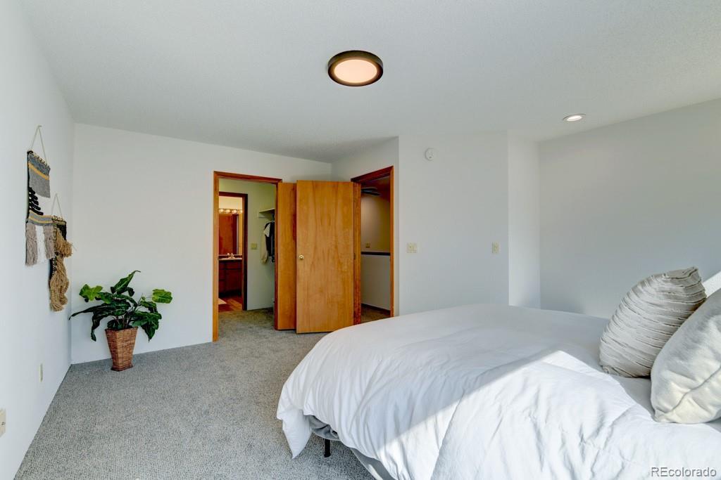 18673 North Elbert Road Elbert, CO 80106 - Photo 28 of 50 a bedroom with a bed and a potted plant