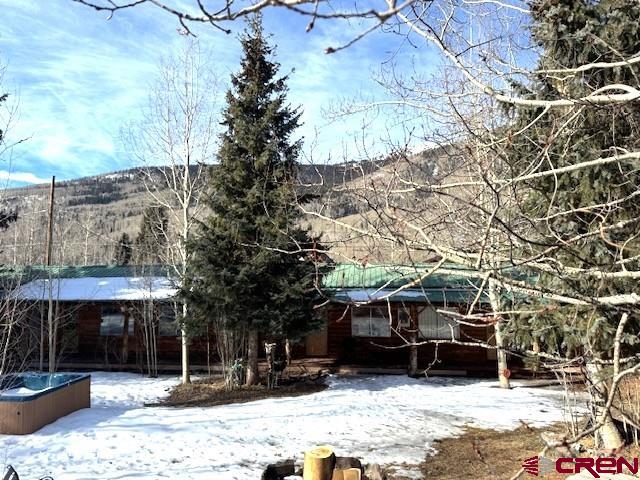 15 South Silver Street Rico, CO 81332 - Photo 1 of 15 a view of a house with a yard covered in snow