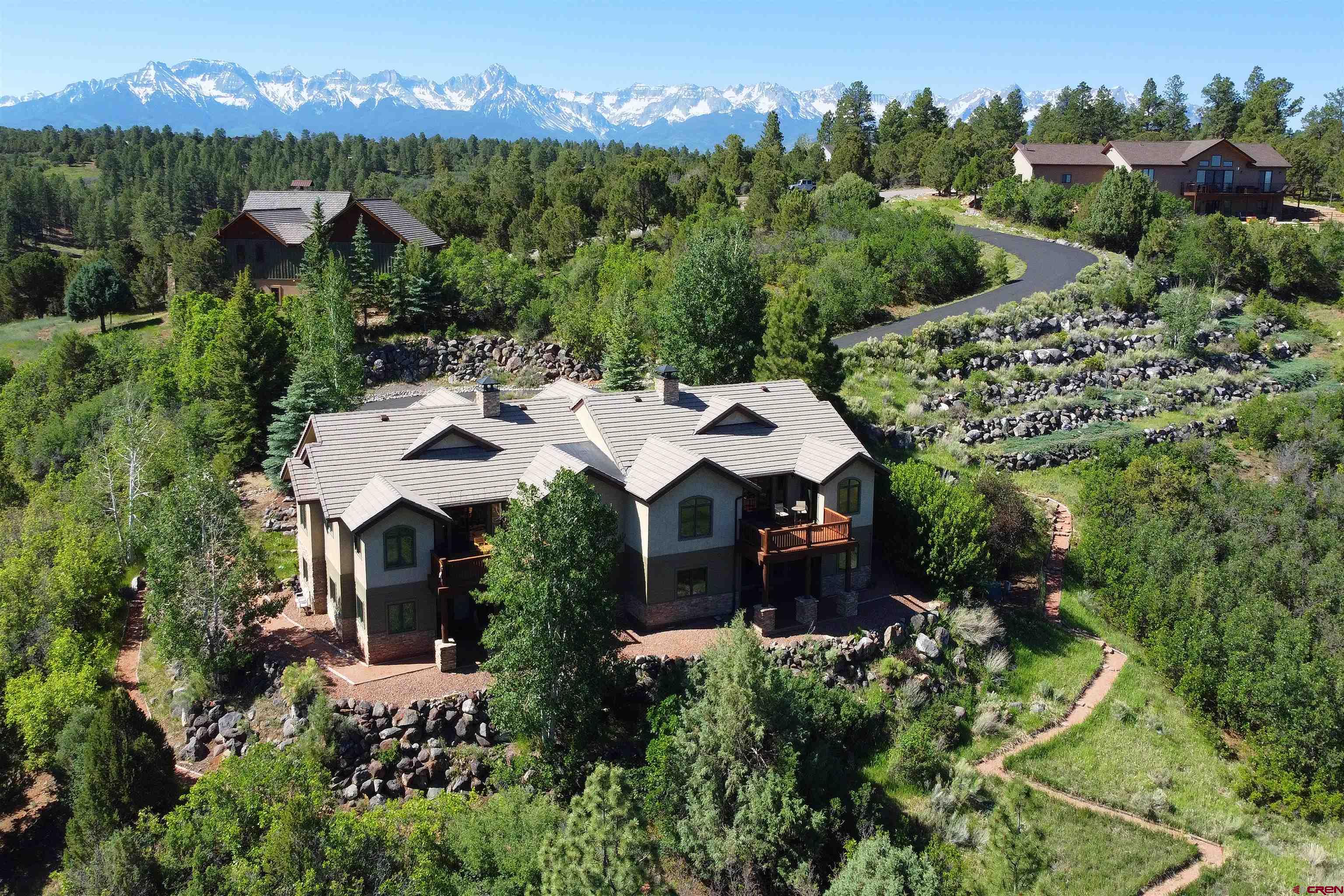 an aerial view of a house with yard and outdoor seating