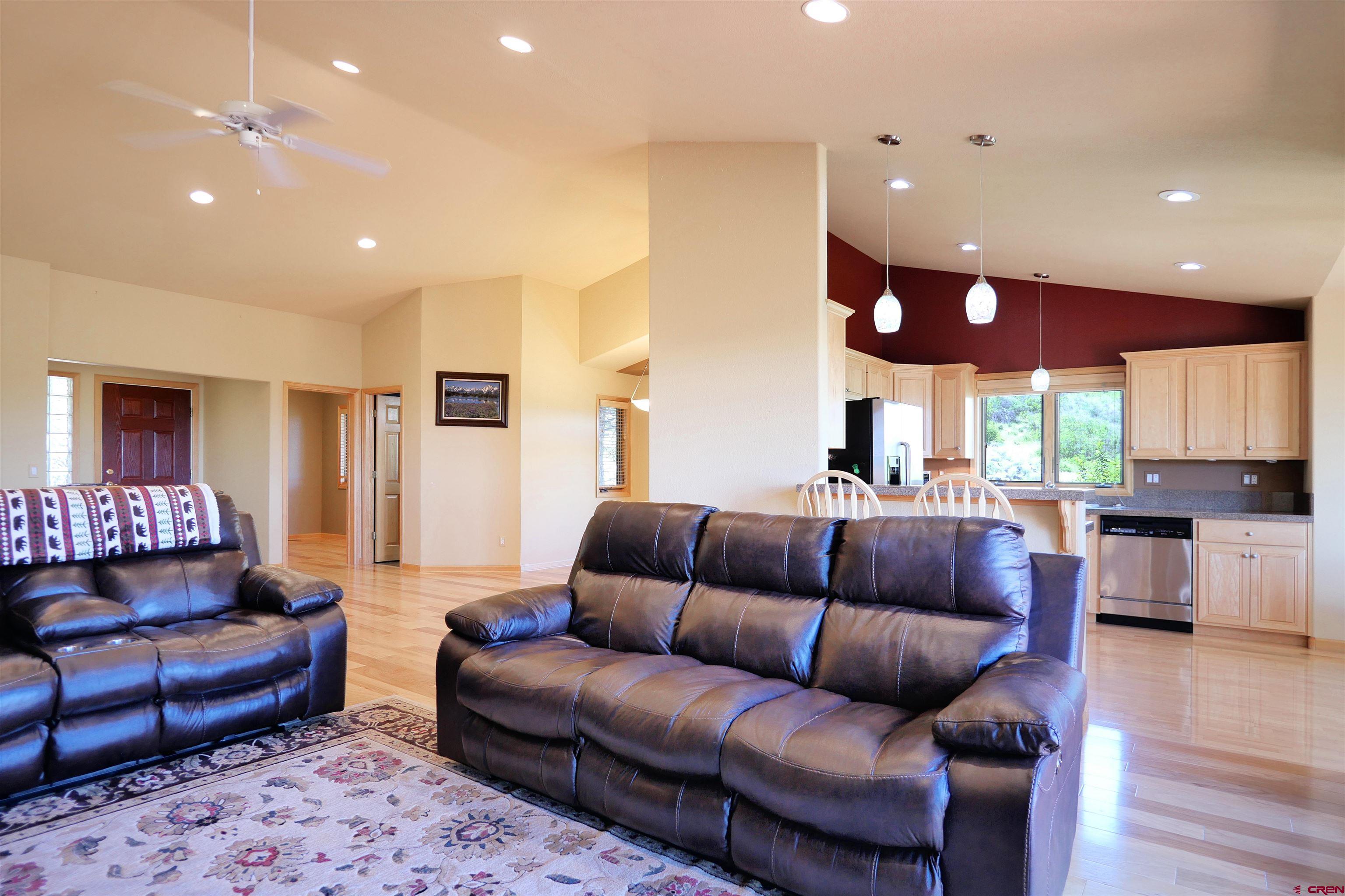 201 Woodchuck Place Ridgway, CO 81432 - Photo 13 of 33 a living room with furniture ceiling fan and wooden floor